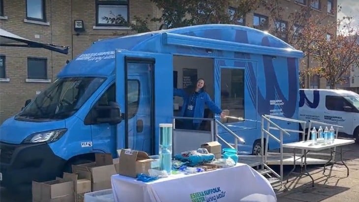 Community events - Sandy - table setup outside of vehicle with colleague