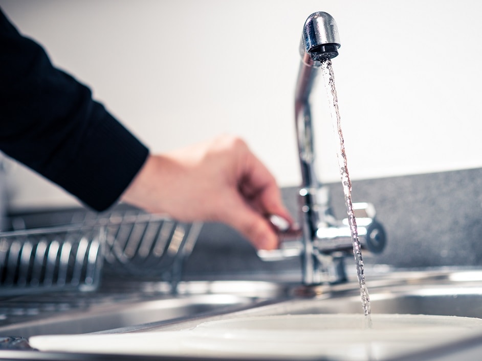 Person running tap water