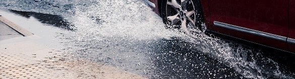 car driving through water leak