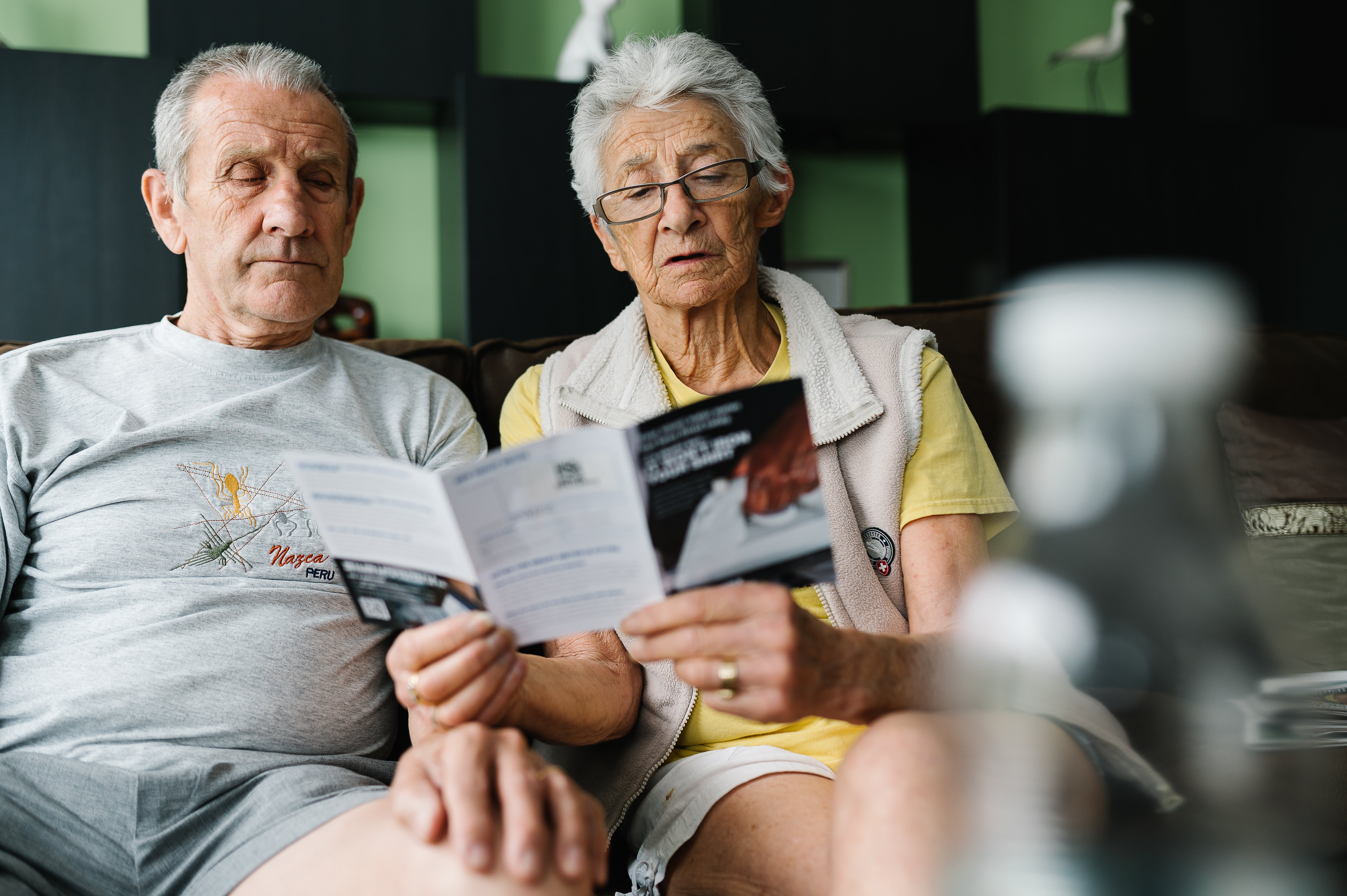 man and woman reading leaflet