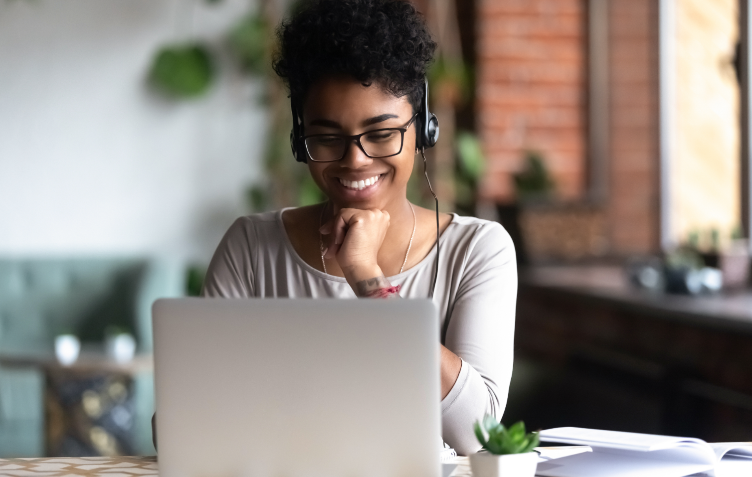 women with headset using laptop