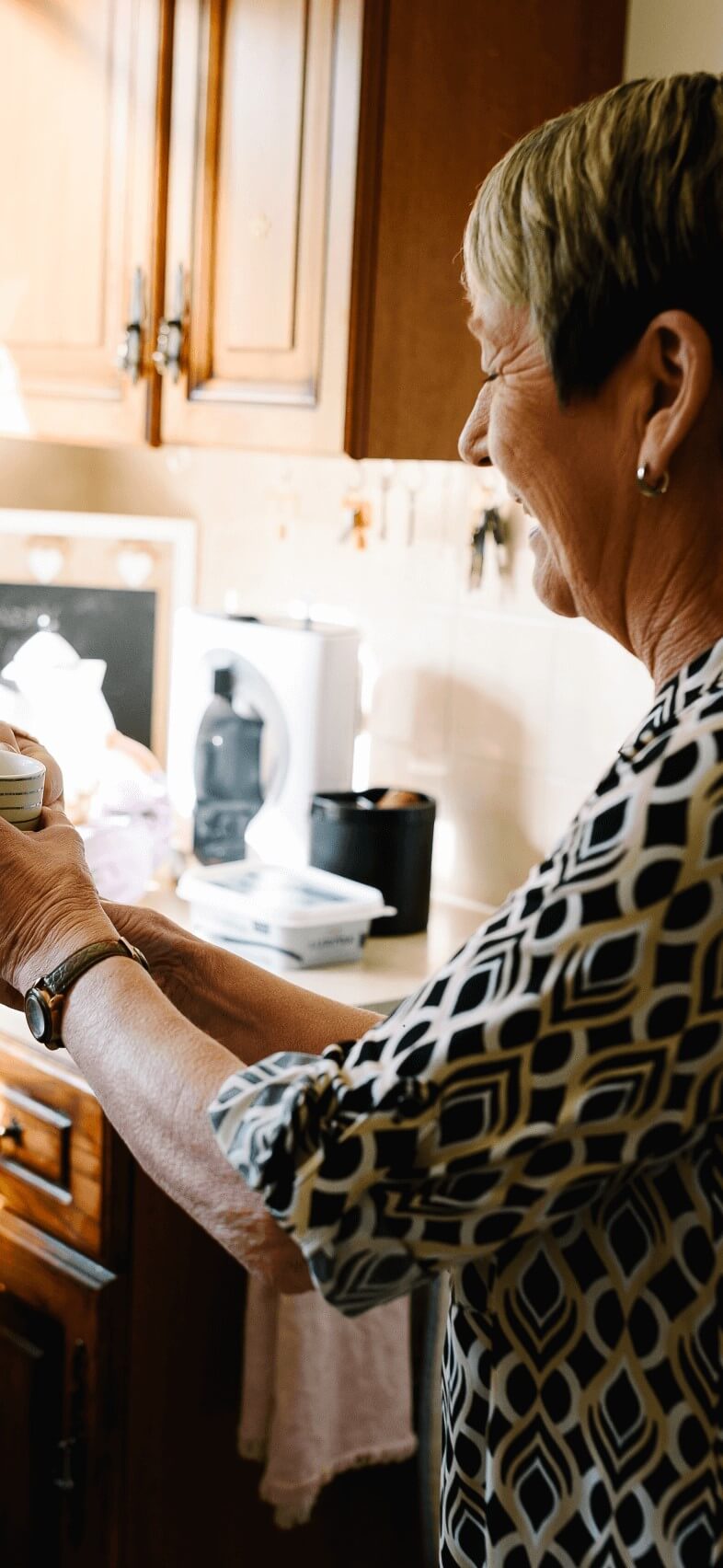 Woman in kitchen with a cuppa