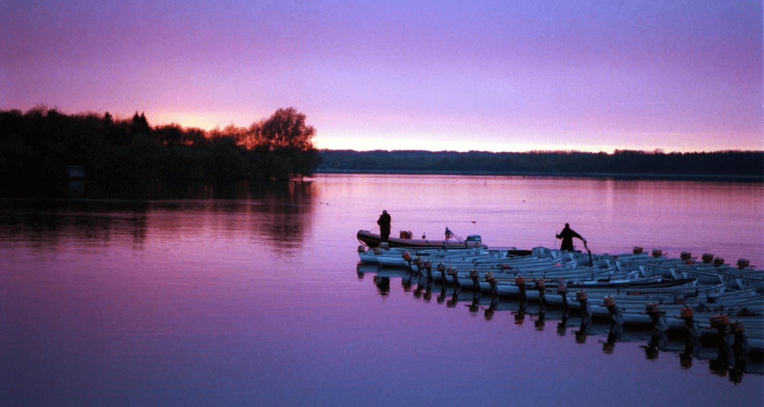 Hanningfield Waterside Park in Essex with two fishermen and boats